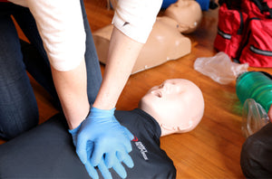 girl with gloves on doing CPR